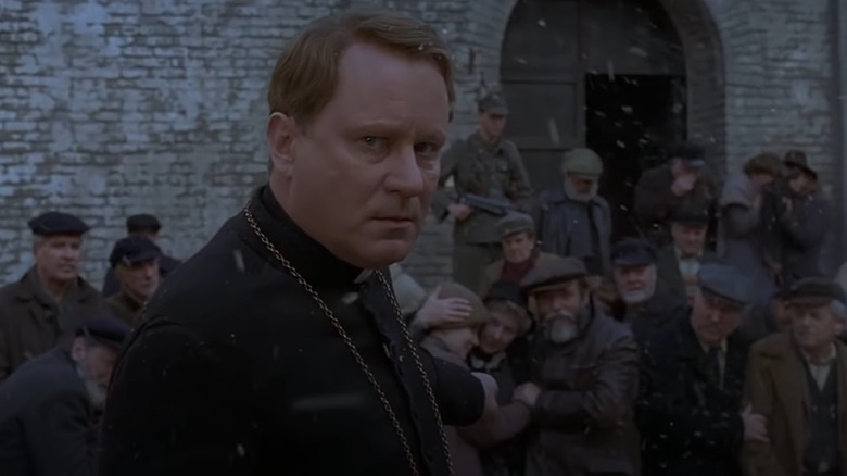 Father Merrin pointing at crowd