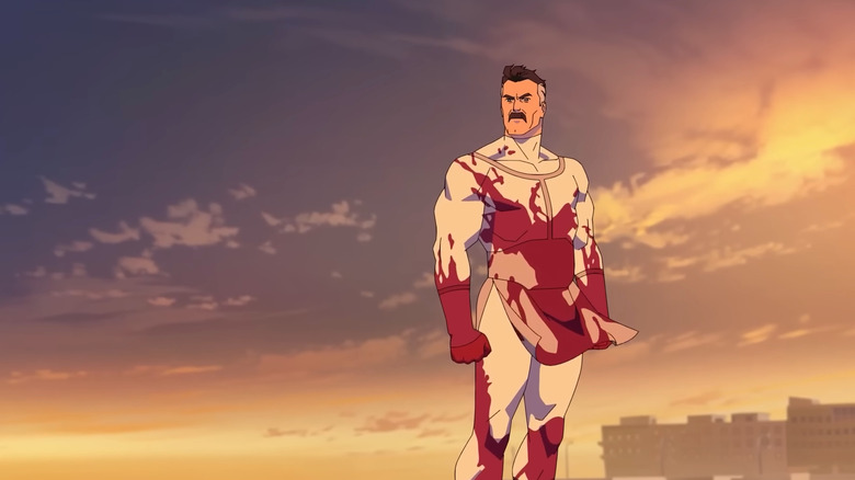 Nolan Grayson covered in blood on an Earth beach