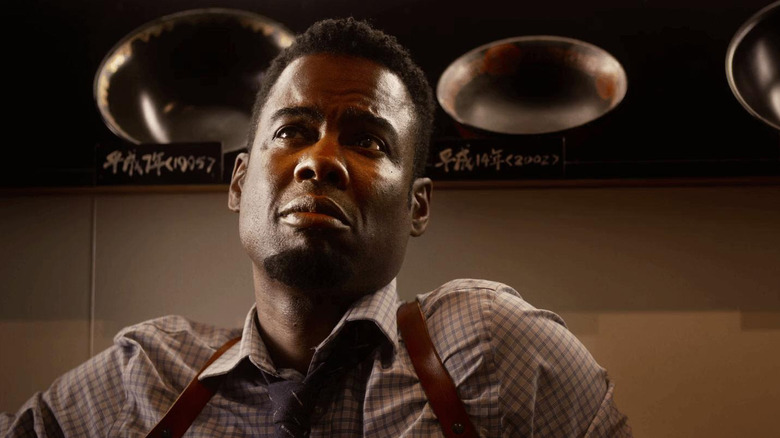 Chris Rock as Zeke Banks drinking at a bar in Spiral