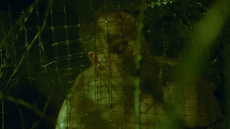 Mike Butters as Paul Leahy trapped in razor wire in Saw