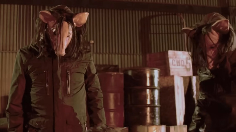 Pig masks look down in Saw 7