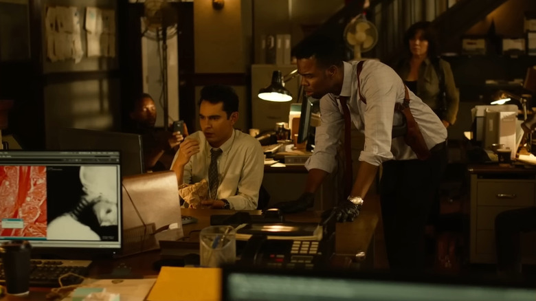 Chris Rock and Frank Licari as Zeke and Schenk looking at a computer in Spiral