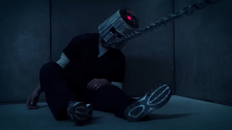 Matt Passmore as Logan Nelson in the bucket head trap in Jigsaw
