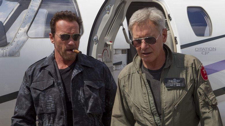Trench Mauser and Max Drummer walking away from a helicopter together in The Expendables 3