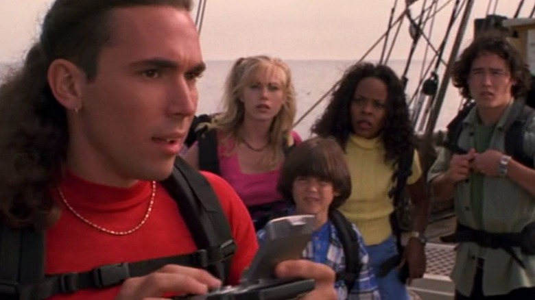 Tommy talks on his comm while the other Rangers watch in Power Rangers Turbo