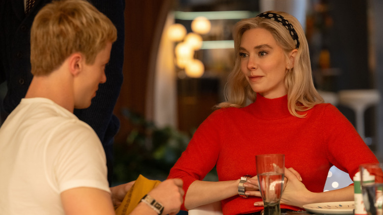 Johnny Storm (Joseph Quinn) and Sue Storm (Vanessa Kirby) sit at a table in The Fantastic Four: First Steps