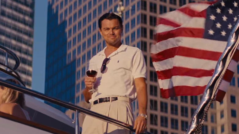 Jordan Belfort holding a glass of wine