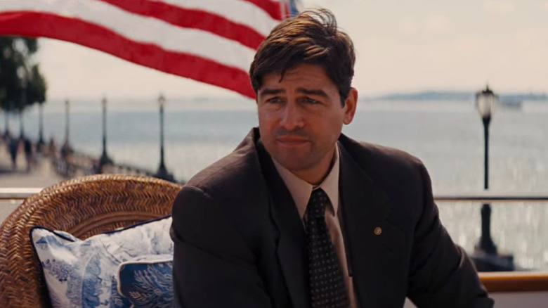 Agent Patrick Denham sitting by American flag