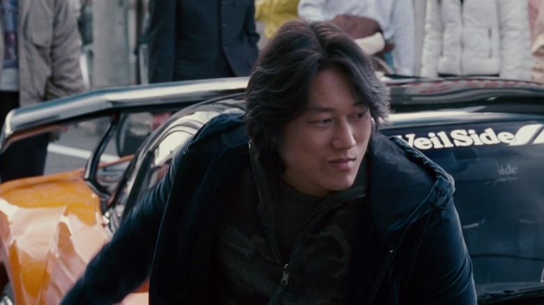 Han in front of a car in The Fast and the Furious: Tokyo Drift