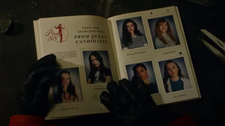 Gloved hands on a high school yearbook in Fear Street: Prom Queen