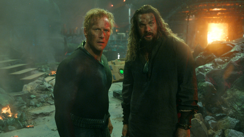 Patrick Wilson as Orm and Jason Momoa as Aquaman standing amidst rubble in Aquaman and the Lost Kingdom