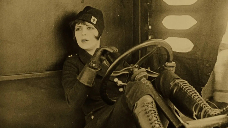 Mary Preston in her nurse outfit driving a jeep in Wings