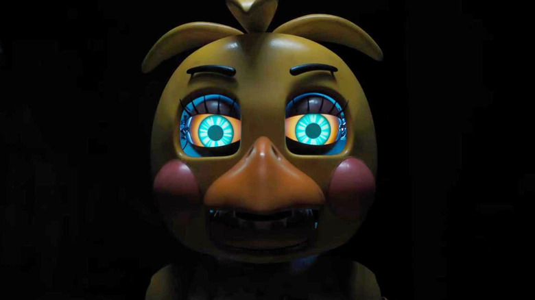 Dilapilated Chica animatronic with glowing eyes in Five Nights at Freddy's 2