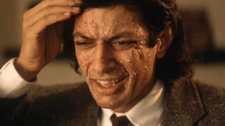 Seth Brundle with pustules on his face in The Fly
