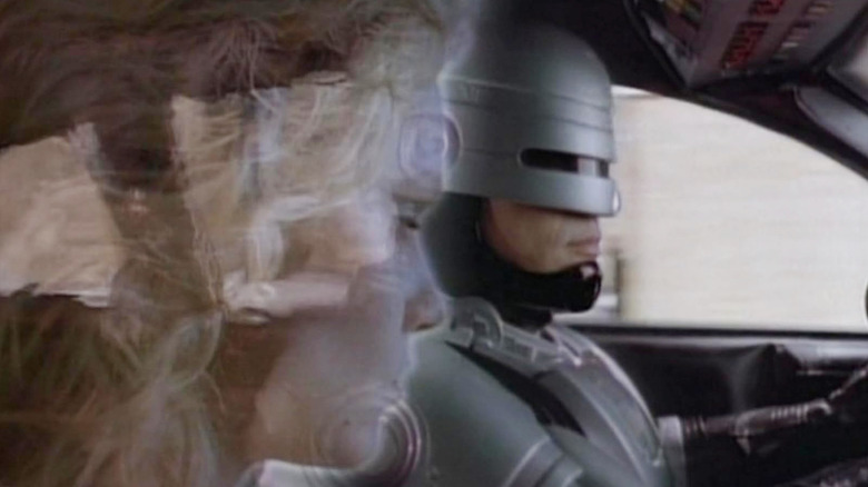 RoboCop driving his car with Diana in the passenger's seat in RoboCop (1994)
