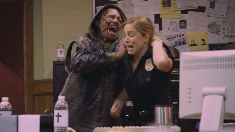 A zombie attacking Officer Kirsten on Death Valley