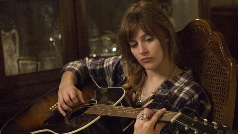 Jem/Jerrica (Aubrey Peeples) playing the guitar in Jem and the Holograms