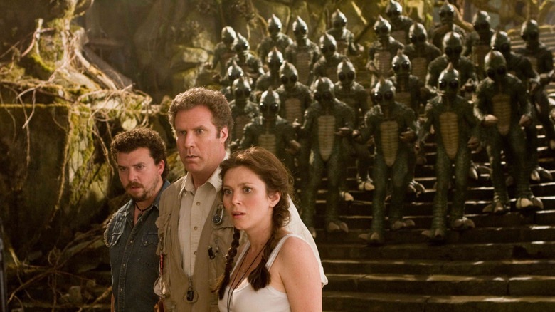 Will, Rick, and Holly from Land of the Lost, an army of Sleestaks sneaking up behind them.