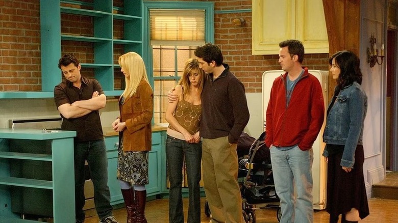 Joey, Phoebe, Ross, Rachel, Chandler, and Monica standing in an empty flat on 