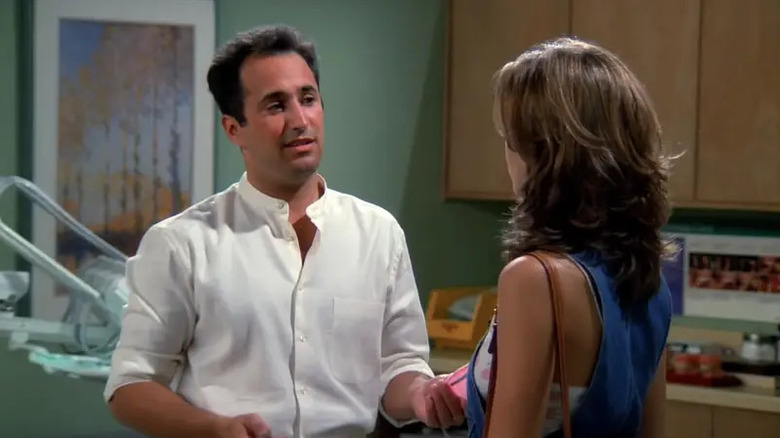 Dr. Barry Farber (Mitchell Whitfield) talks to Rachel Green (Jennifer Aniston) in his dentist office in "Friends"