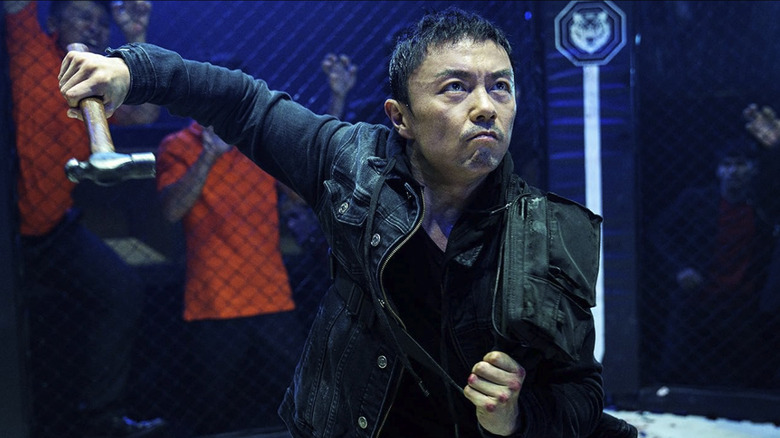 Wang Wei wields a hammer in a UFC-style fighting ring in The Furious