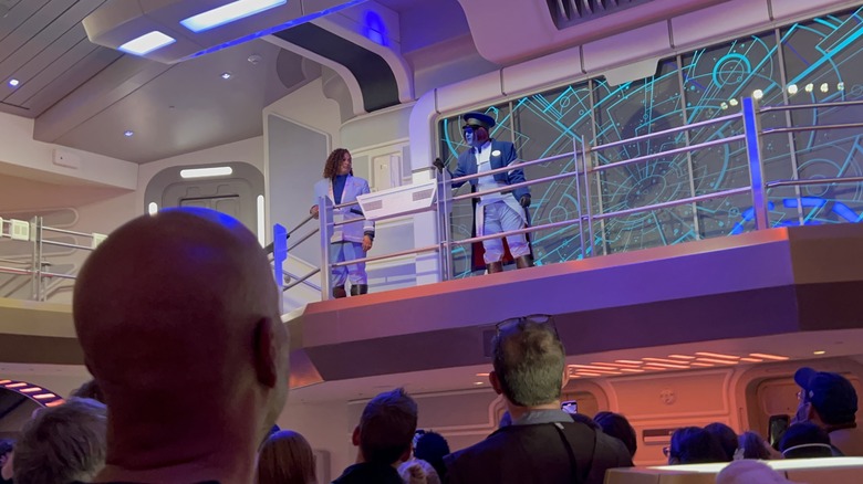 The Captain and Cruise Director address the passengers aboard the Halcyon