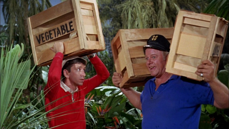 Gilligan and the Skipper holding big vegetable boxes in an episode of Gilligan's Island