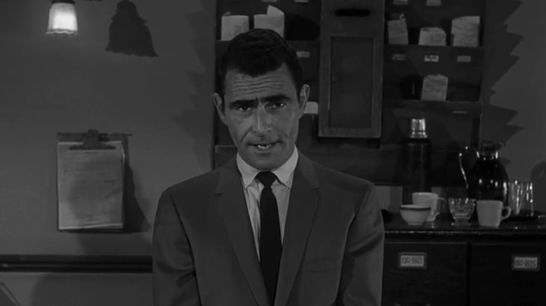 Rod Serling stands addressing the camera in The Twilight Zone
