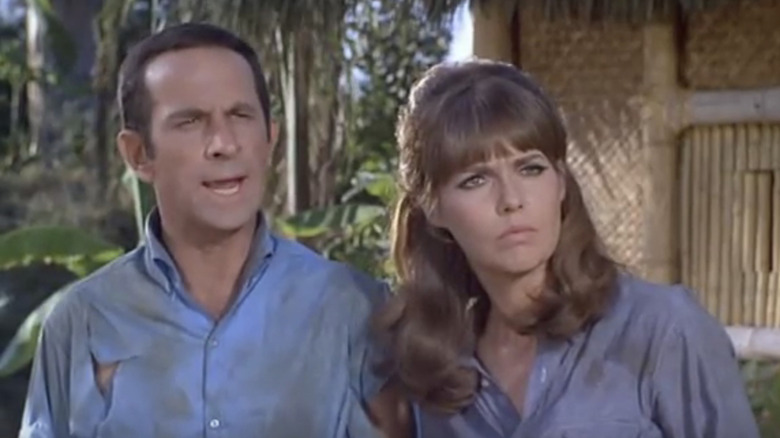 Don Adams' Maxwell Smart stands beside Barbara Feldon's Agent 99 next to a shack in Get Smart