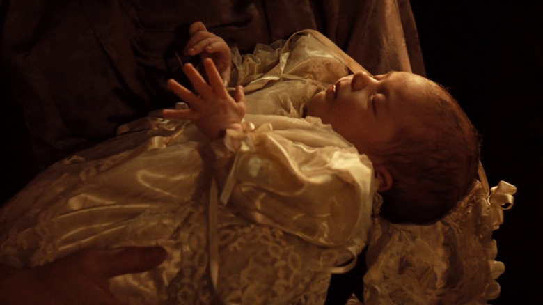 The baptism coincides with the fulfillment of Michael's violent plans