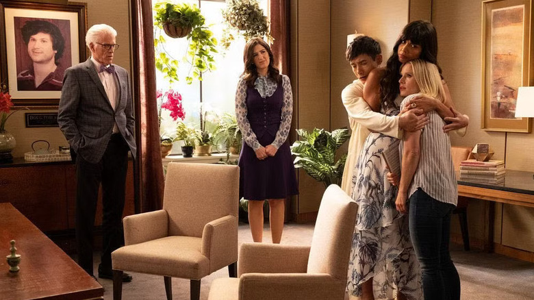 Michael and Janet watching Jason and Tahani hug Eleanor on The Good Place