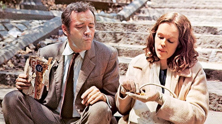 man and woman on steps eating