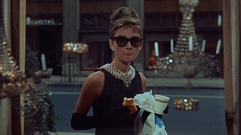 Audrey Hepburn, staring through shop window