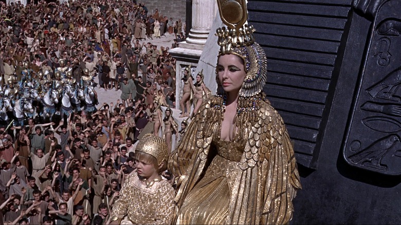Elizabeth Taylor seated, looking on