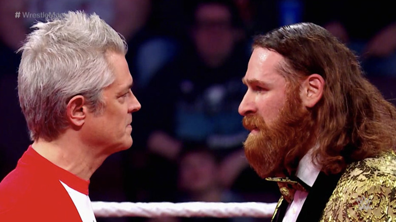 Johnny Knoxville and Sami Zayn have a stare down before their Wrestlemania match