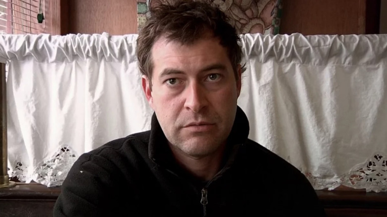 Mark Duplass looking forlorn, staring down the camera while sitting in a diner in Creep