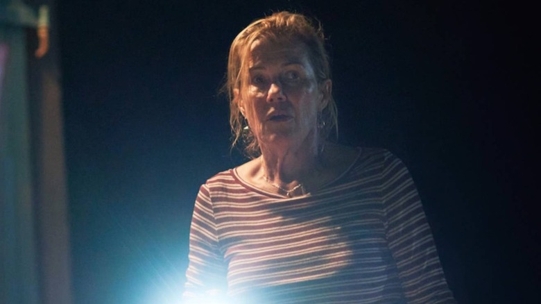 Verity waving a flashlight in The Survivors