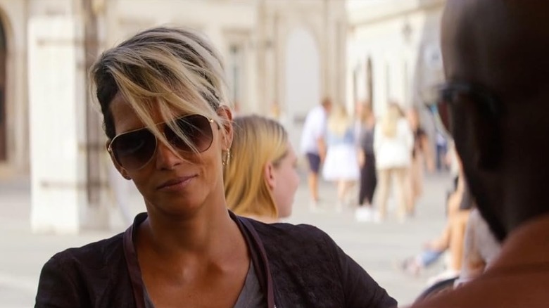 Halle Berry as Roxanne Hall smiling while wearing sunglasses in The Union