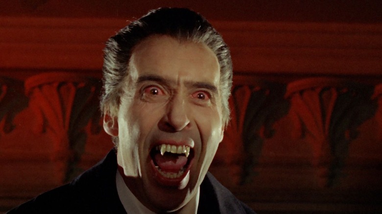 Dracula bearing his fangs in a red room in Horror of Dracula