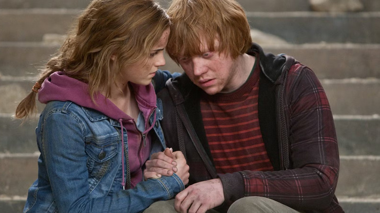 Hermione Granger (Emma Watson) and Ron Weasley (Rupert Grint) find comfort in one another in "Harry Potter and the Deathly Hallows: Part 2"