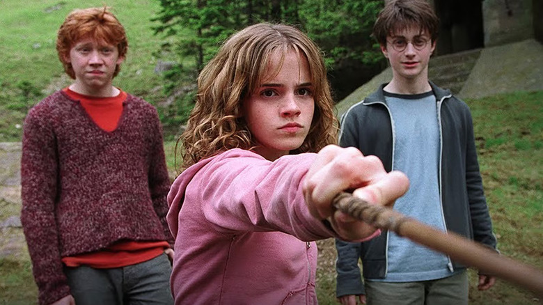 Hermione Granger (Emma Watson) points her wand, while Ron Weasley (Rupert Grint) and Harry Potter (Daniel Radcliffe) stand behind her in "Harry Potter and the Prisoner of Azkaban"