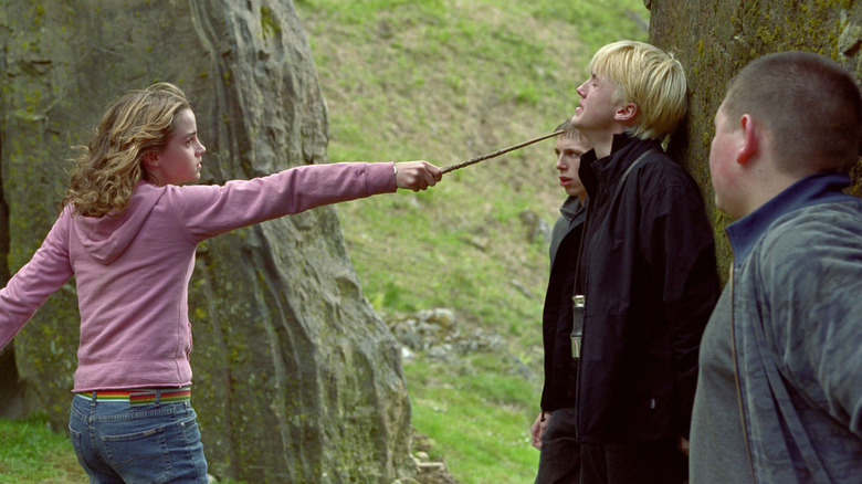 Hermione Granger (Emma Watson) points her wand towards the throat of Draco Malfoy (Tom Felton) in "Harry Potter and the Prisoner of Azkaban"