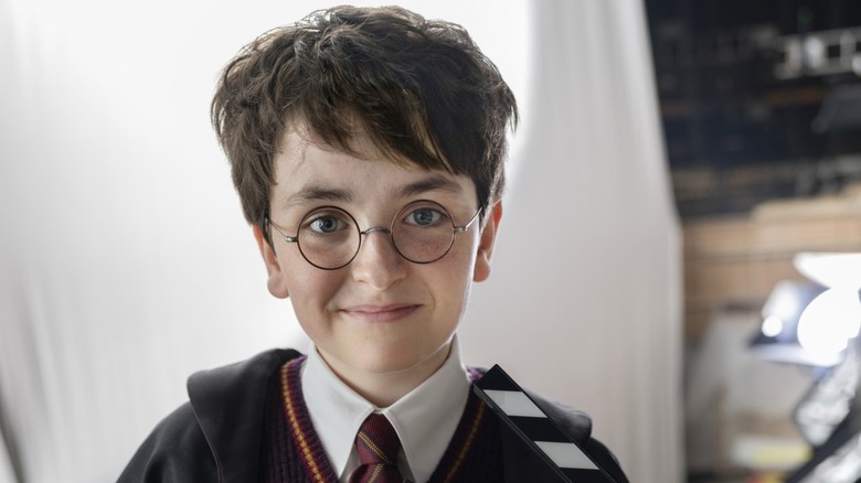 Harry Potter smiling in a promotional still for the HBO series
