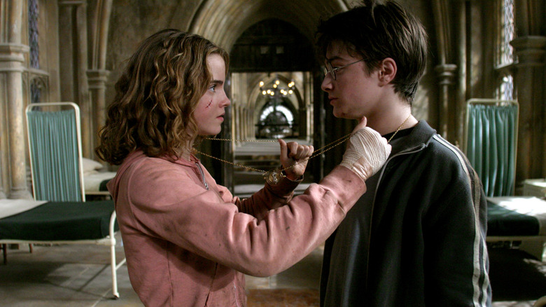 Harry (Daniel Radcliffe) and Hermione (Emma Watson) using a Time Turner in Harry Potter and the Prisoner of Azkaban
