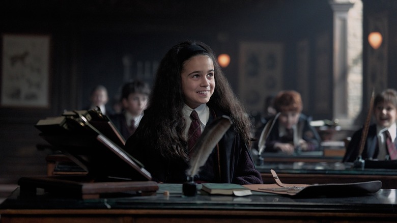 Hermione in class smiling in Harry Potter and the Philosopher's Stone