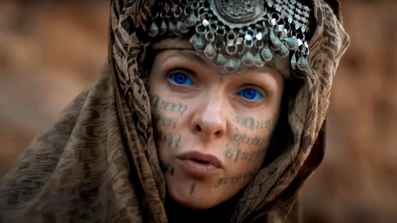 Lady Jessica with runes on her face and a headdress in Dune