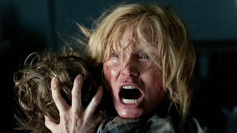 Amelia (Essie Davis) screams and holds her son Samuel (Noah Wiseman ) in The Babadook (2014)