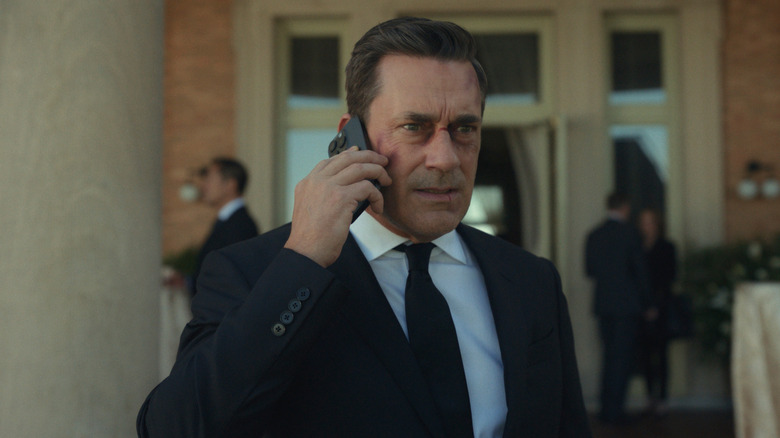 Coop with a cut on his nose wearing a suit on the phone in Your Friends and Neighbors