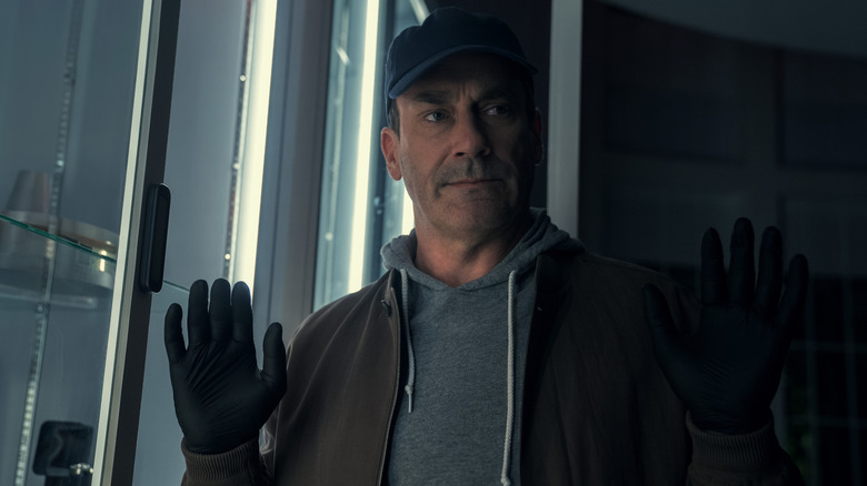 Coop in a baseball cap and gloves holding up his hands in surrender in Your Friends and Neighbors