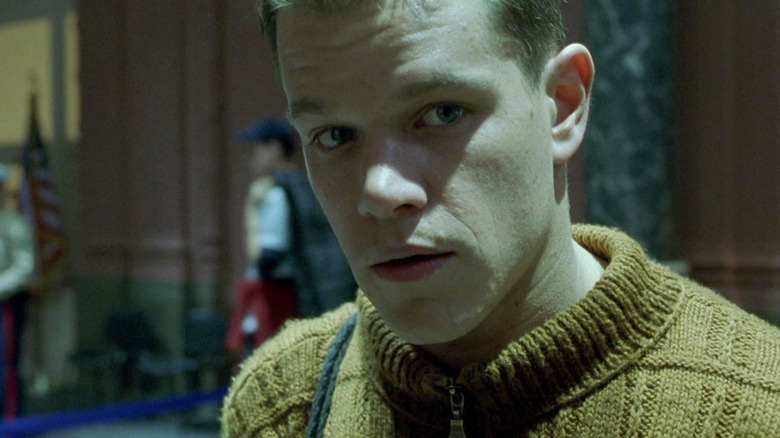 Matt Damon as Jason Bourne standing in a bank in The Bourne Identity